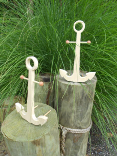 Wooden anchors sitting on piligs