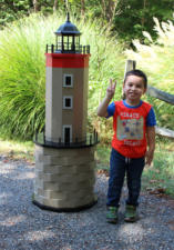 My son standing next to the Bastia Lighthouse replica